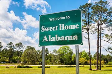 A green road sign that says